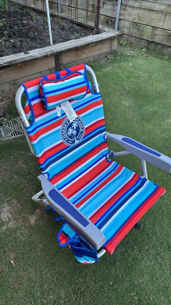 Tommy Bahama beach chair showing its pockets, pillow, and backpack straps