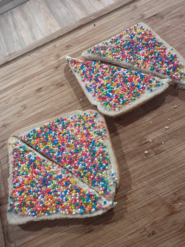 Plate of Australian fairybread — buttered white bread covered in rainbow hundreds and thousands