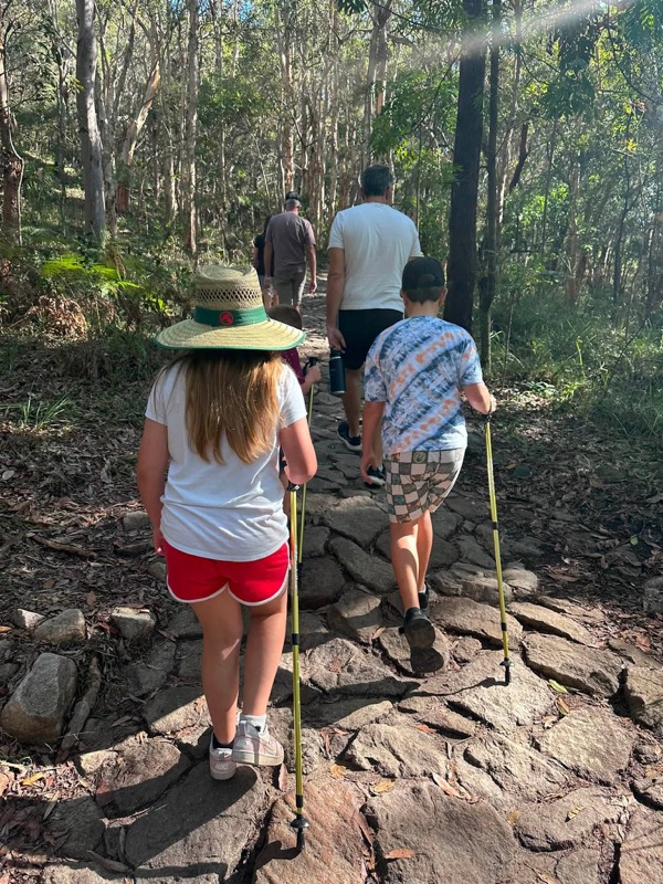 Kids setting off on the Mount Coolum hike with hiking poles, Sunshine Coast