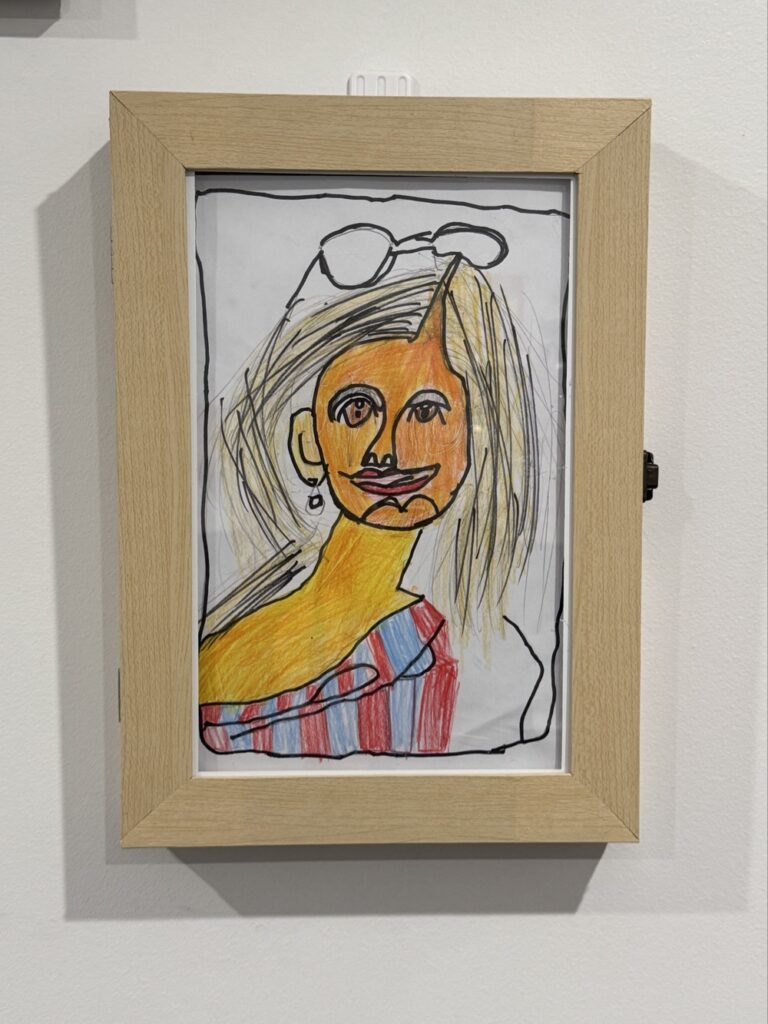 A child's drawing of a woman with a stripey dress