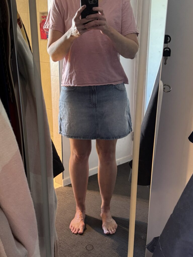 Trying on a denim skirt from last year while planning holiday capsule wardrobe