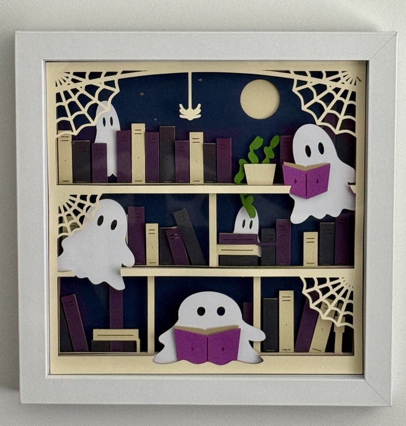 Finished layered Halloween shadow box with ghosts and books